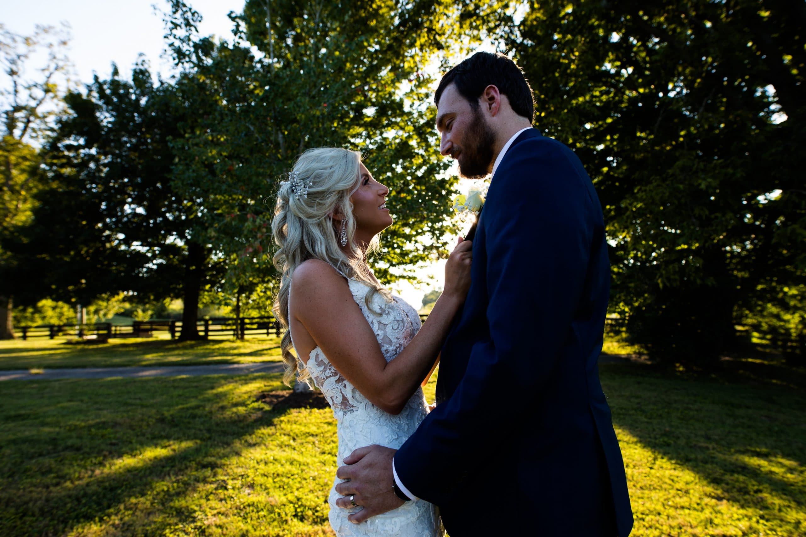 Bride and groom in a close embrace, bride pinching groom's lapel